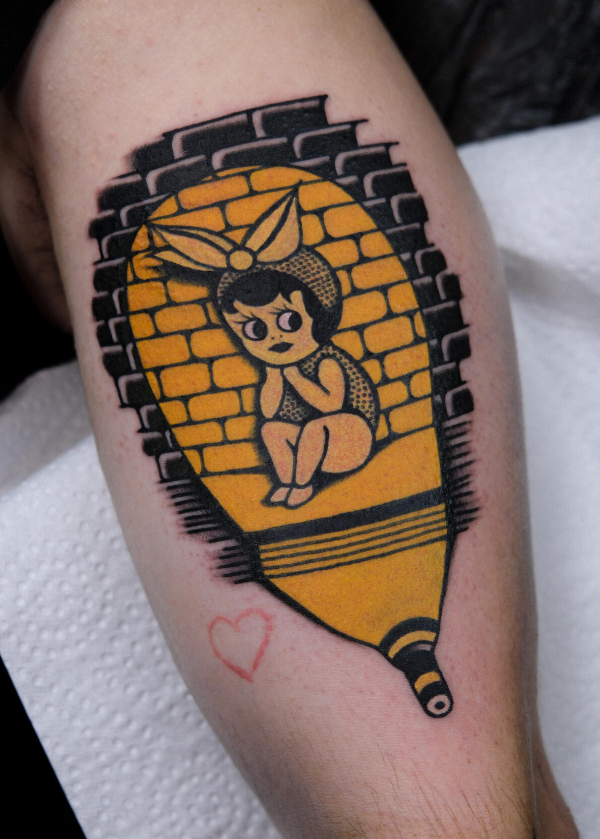“Lost and Found” traditional tattoo of a girl with a brick background, made in Amsterdam